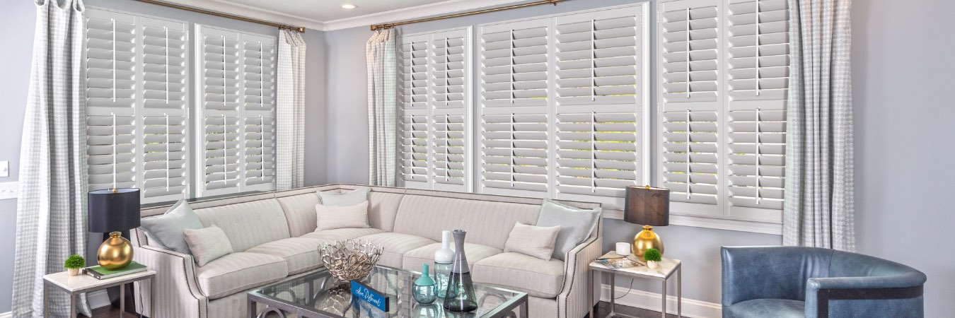 Classic white plantation shutters in living room.